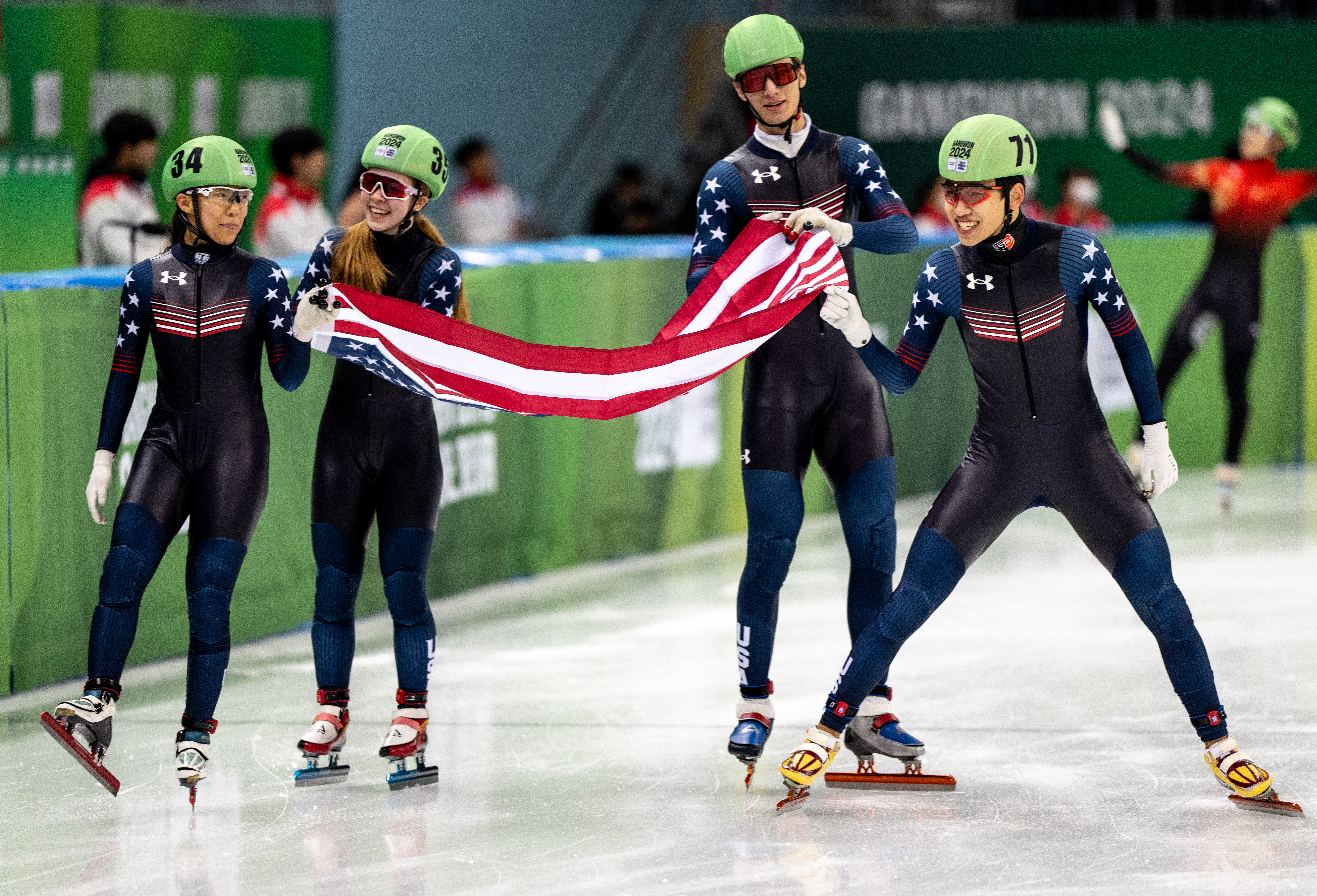 Kyung Eun Jang (USA), Eliza Rhodehamel (USA), Julius Kazanecki (USA) and Sean Boxiong Shuai (USA) celebrate with the national flag of the United States