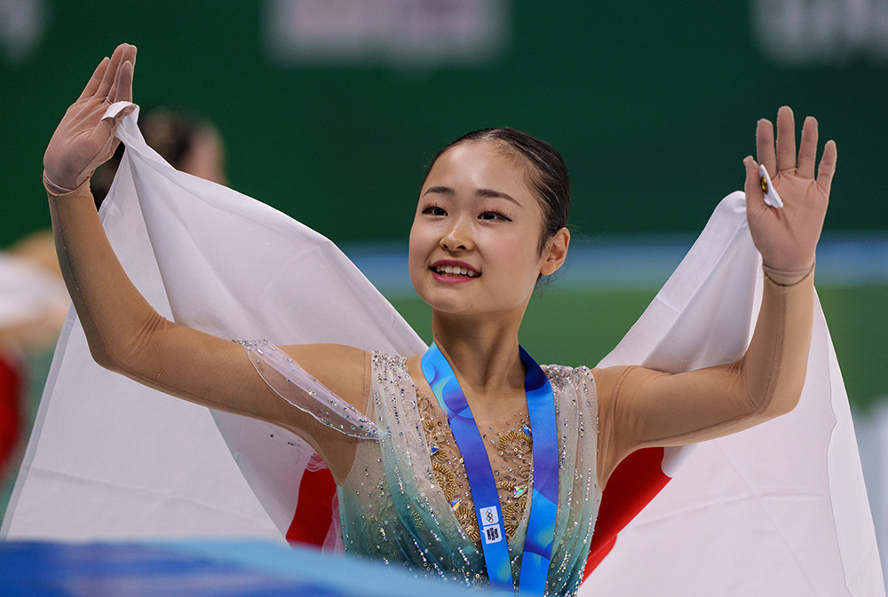 Gold medalist Shimada Mao (JPN) on the ice with after the Women's Singles medal ceremony